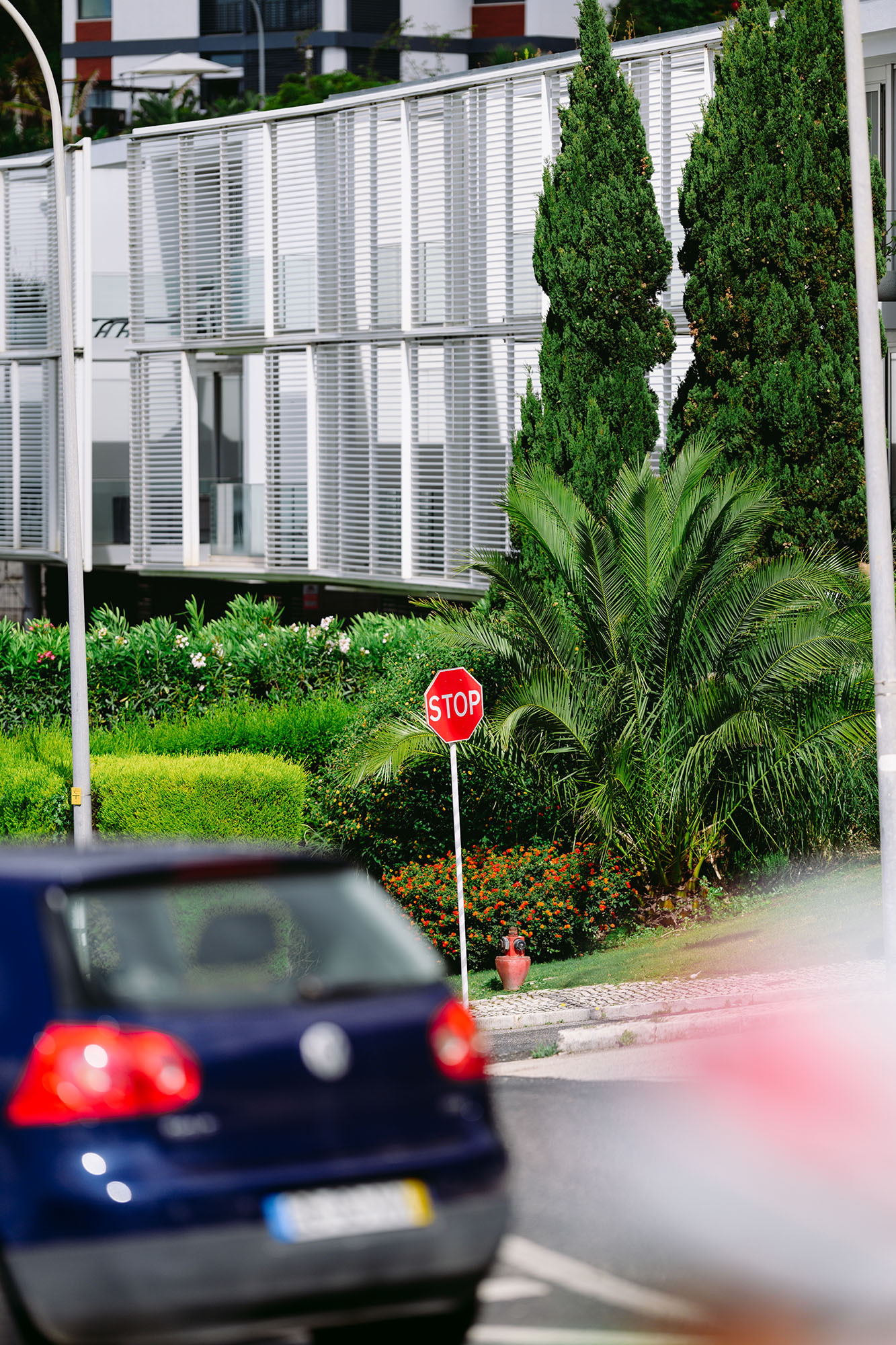 Crooked stop signal sign just before the rain in Caxias, Portugal