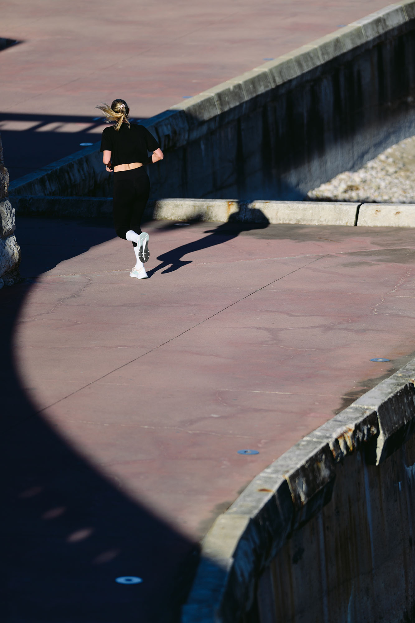 Runner blending in with the shade in Oeiras, Portugal