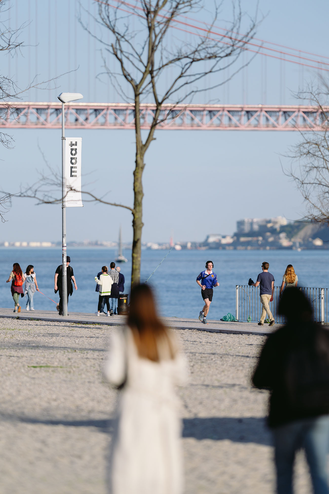 Man running along the Tagus river in Belem area of Lisbon, Portugal